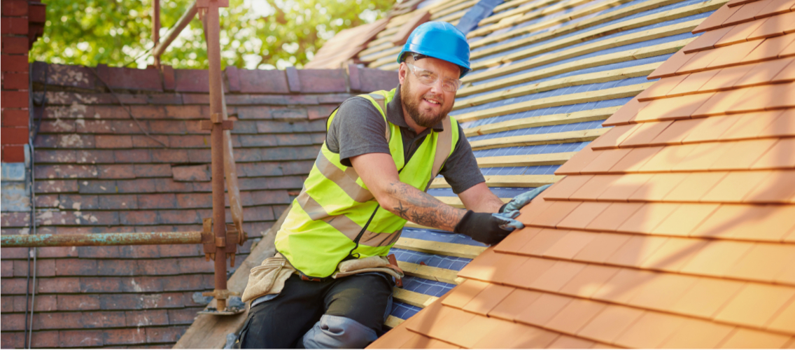 Roofer reviewing paperwork before a McKinney re-roof